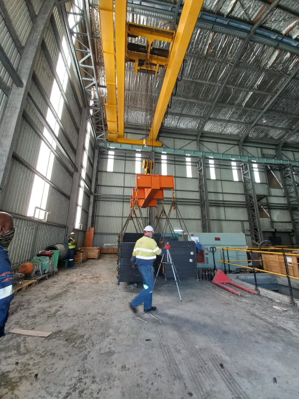 Inspector performing load test on overhead crane